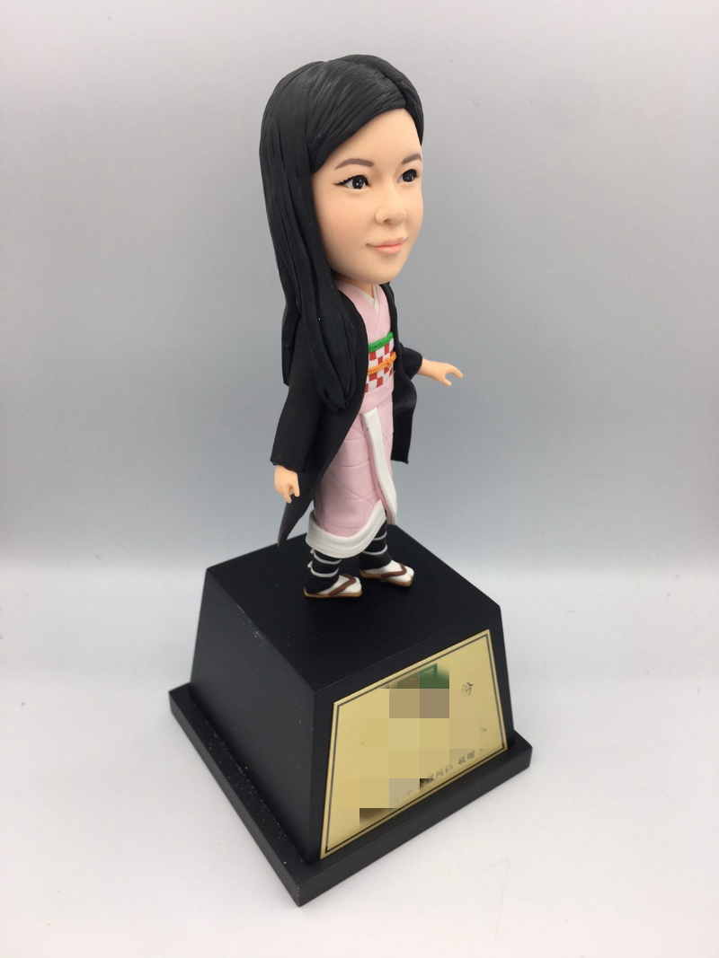 Side view showing the shape and details of a clay portrait doll