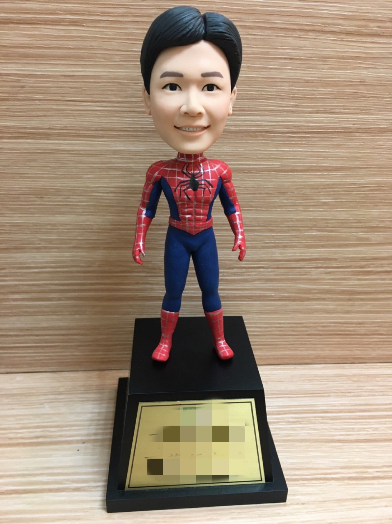 Front view of a clay portrait in a red and blue costume